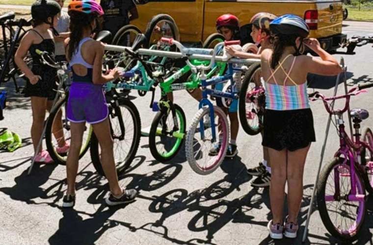 During a mini-training clinic, Girl Scout Brownies Troop 61400 practice racking their bikes and making the transition from the bike to the run.